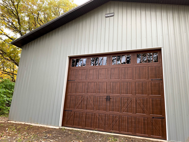 Amarr Classica 3000 in Walnut with Lucern Panels and Thames Windows.  Installed by Augusta Garage Door in Clearwater, MN.