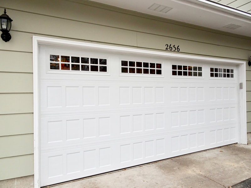 Amarr Designer's Choice in White with Recessed Panels, Insulated Glass, and Stockton Windows.  Installed by Augusta Garage Door in St. Cloud, MN.