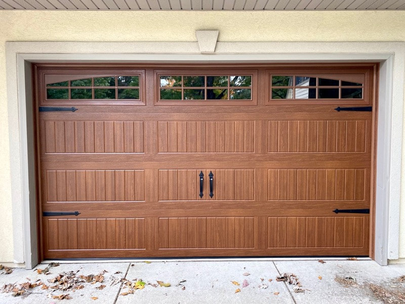 Wayne Dalton Garage Door Model 8300 in Golden Oak, Sonoma Ranch Panels, Arched Stockton Windows, and Castle Rock Magnetic Hardware.  Installed by Augusta Garage Door in St. Augusta, MN.