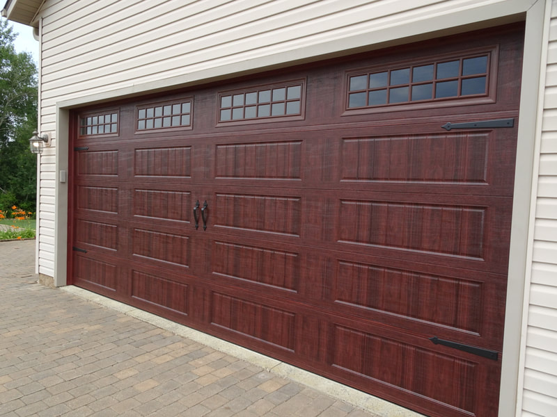 Amarr Designer's Choice Garage Door in Mahogany with LP BB Panels and Stockton Windows.  Installed by Augusta Garage Door in Foley, MN.