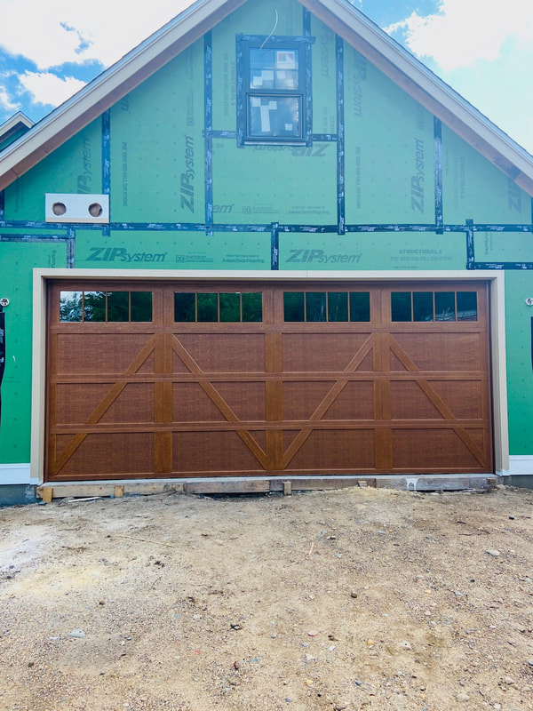 Wayne Dalton Model 9700 in Natural Oak with Charleston Panels and Stockbridge Insulated Glass.  Installed by Augusta Garage Door in Annandale, MN.