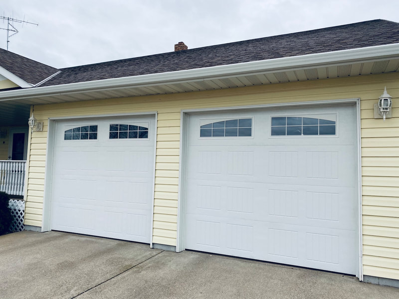 Wayne Dalton Model 8300 in White with Sonoma Panels and Arched Stockton Windows.  Installed by Augusta Garage Door in Avon, MN.